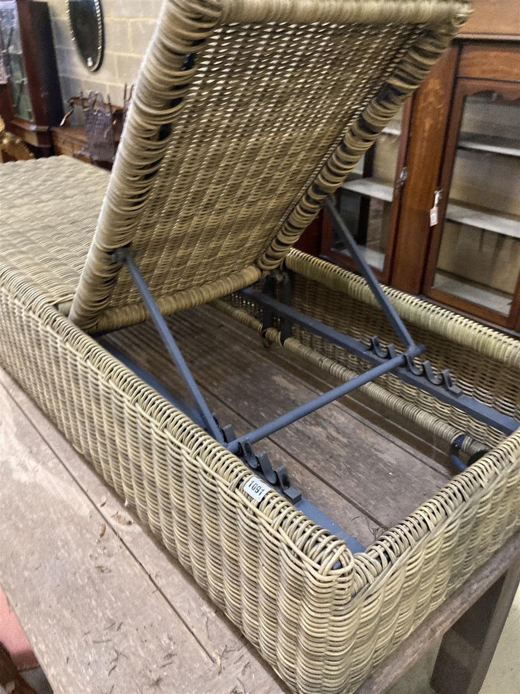 An all weather rattan garden sunlounger with adjustable back, length 210cm, depth 64cm, height 33cm